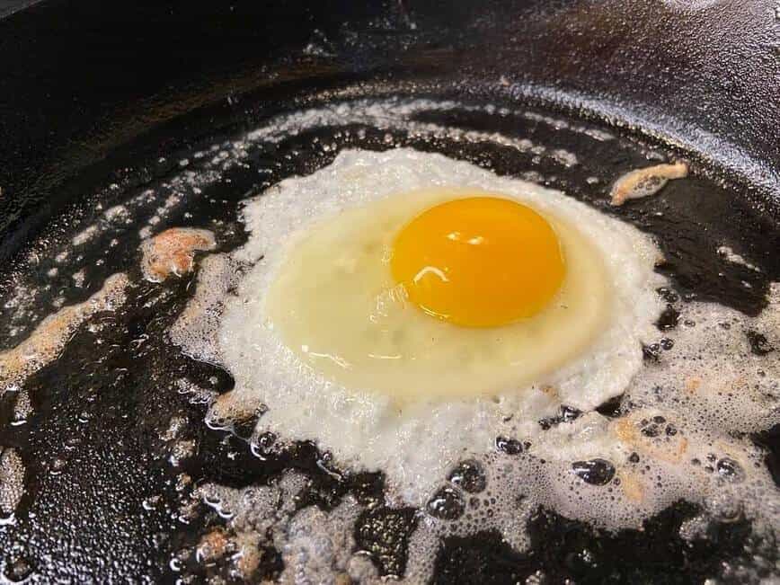 Cooking a sunny side up egg in the same pan.