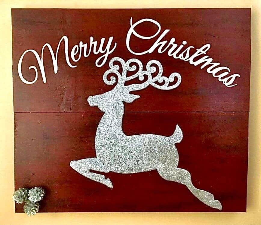 Finished sign, with Merry Christmas, silver glitter deer, and silver glitter pine cones. 