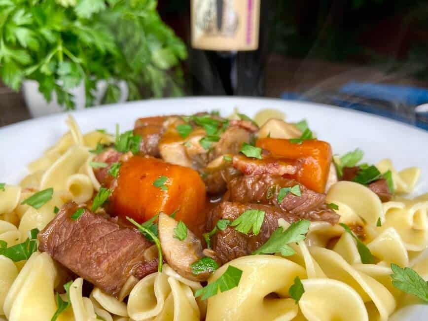 Beef and carrots served over pasta.