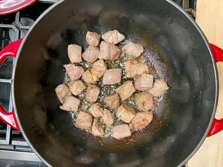 Browning beef in a Dutch oven.