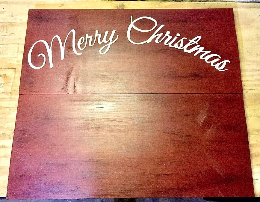 Merry Christmas painted onto front top of sign.