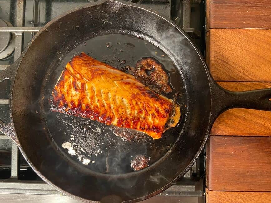 Cooked fish in cast iron pan.