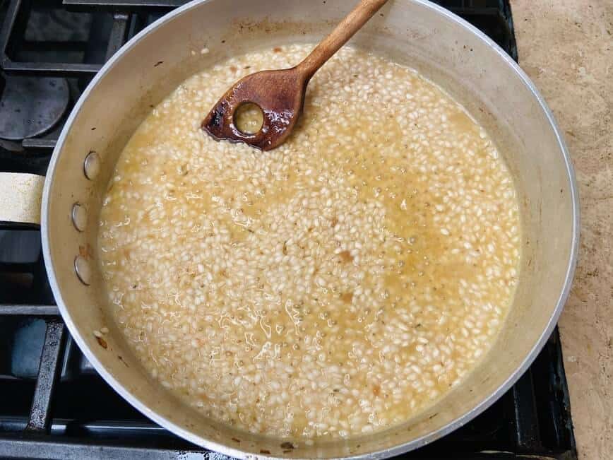 Cooking rice in pan.