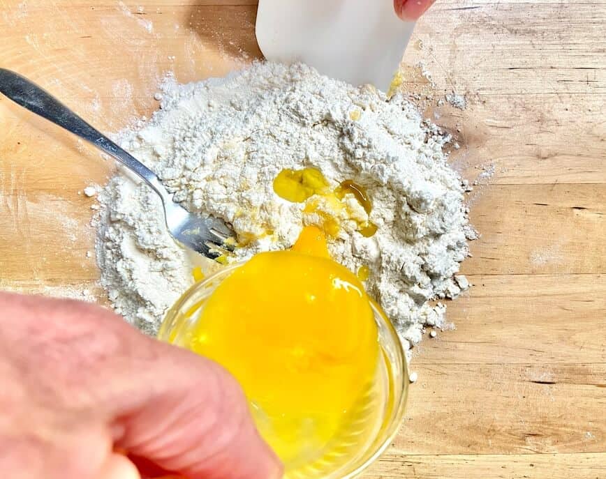 Mixing eggs and flour.
