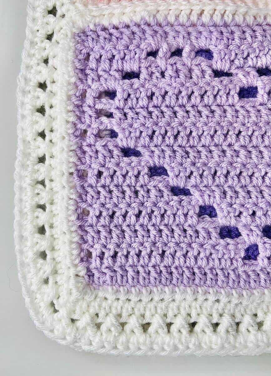 Close up of stitches on heart square.
