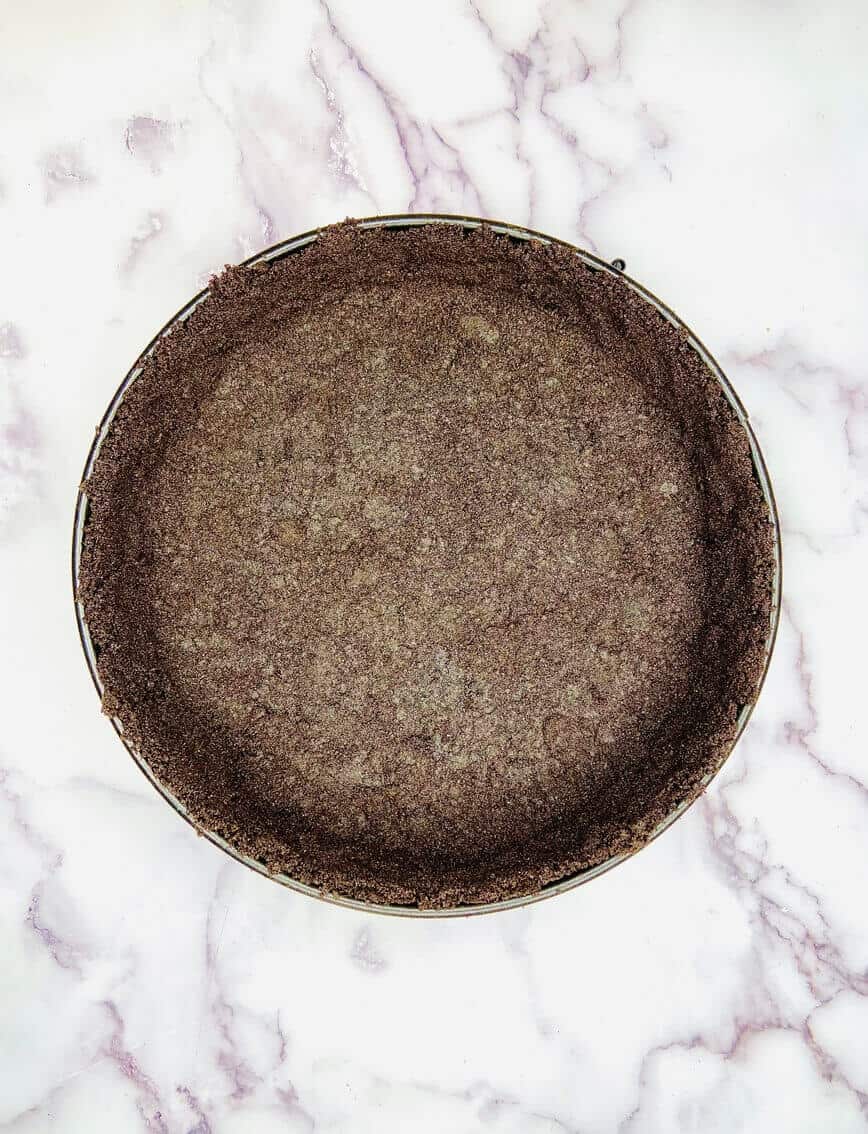 Oreo crust pressed into springform pan.