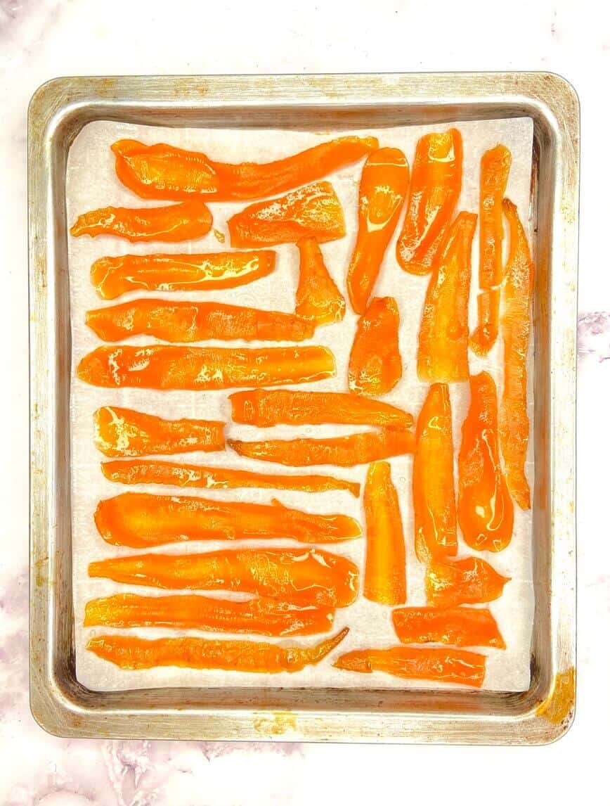 Candied carrot slices on baking sheet.