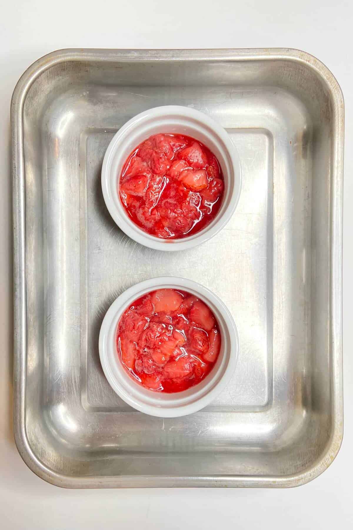 Strawberry puree in bottom of ramekins.