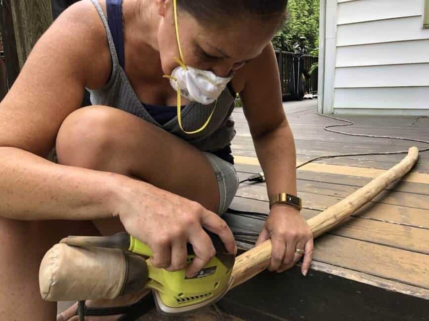 Viana sanding the branch.