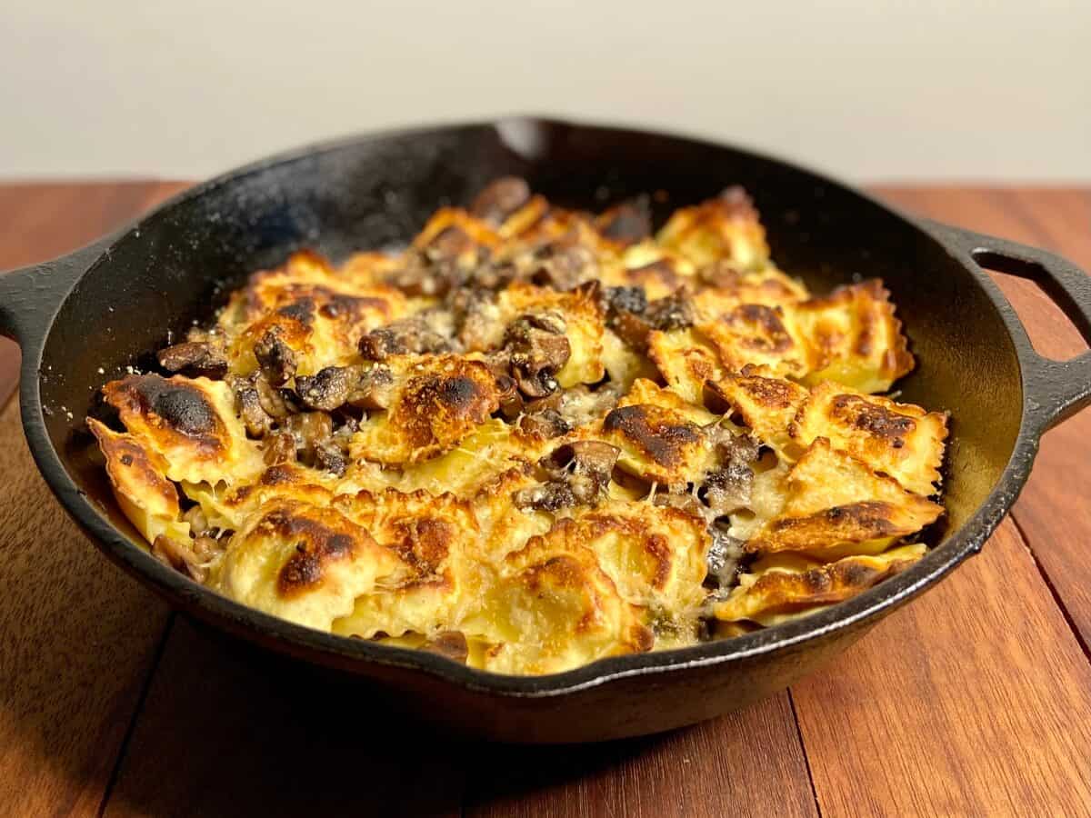 Crispy ravioli in a cast iron pan.