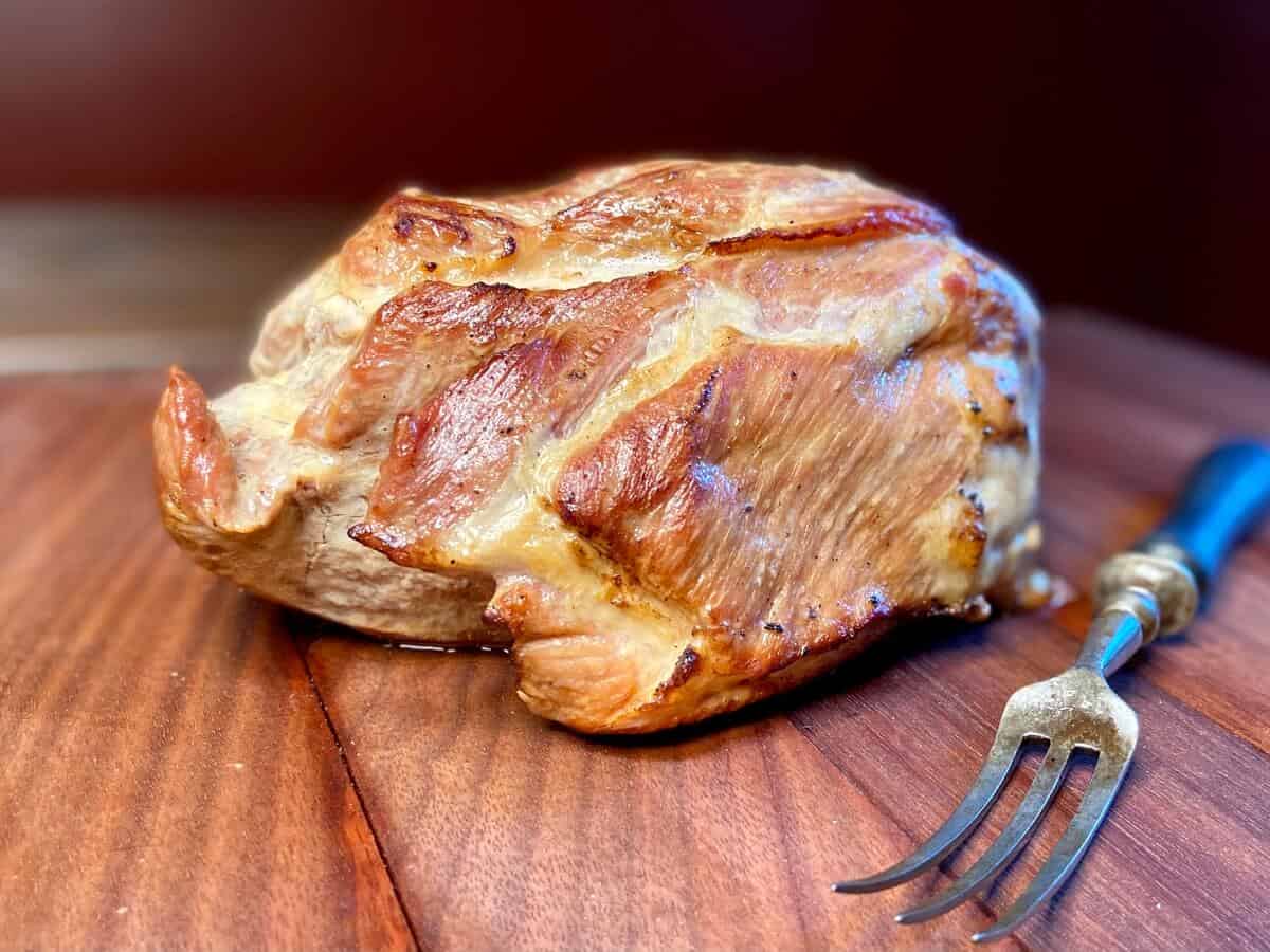 Roasted pork and a large fork.