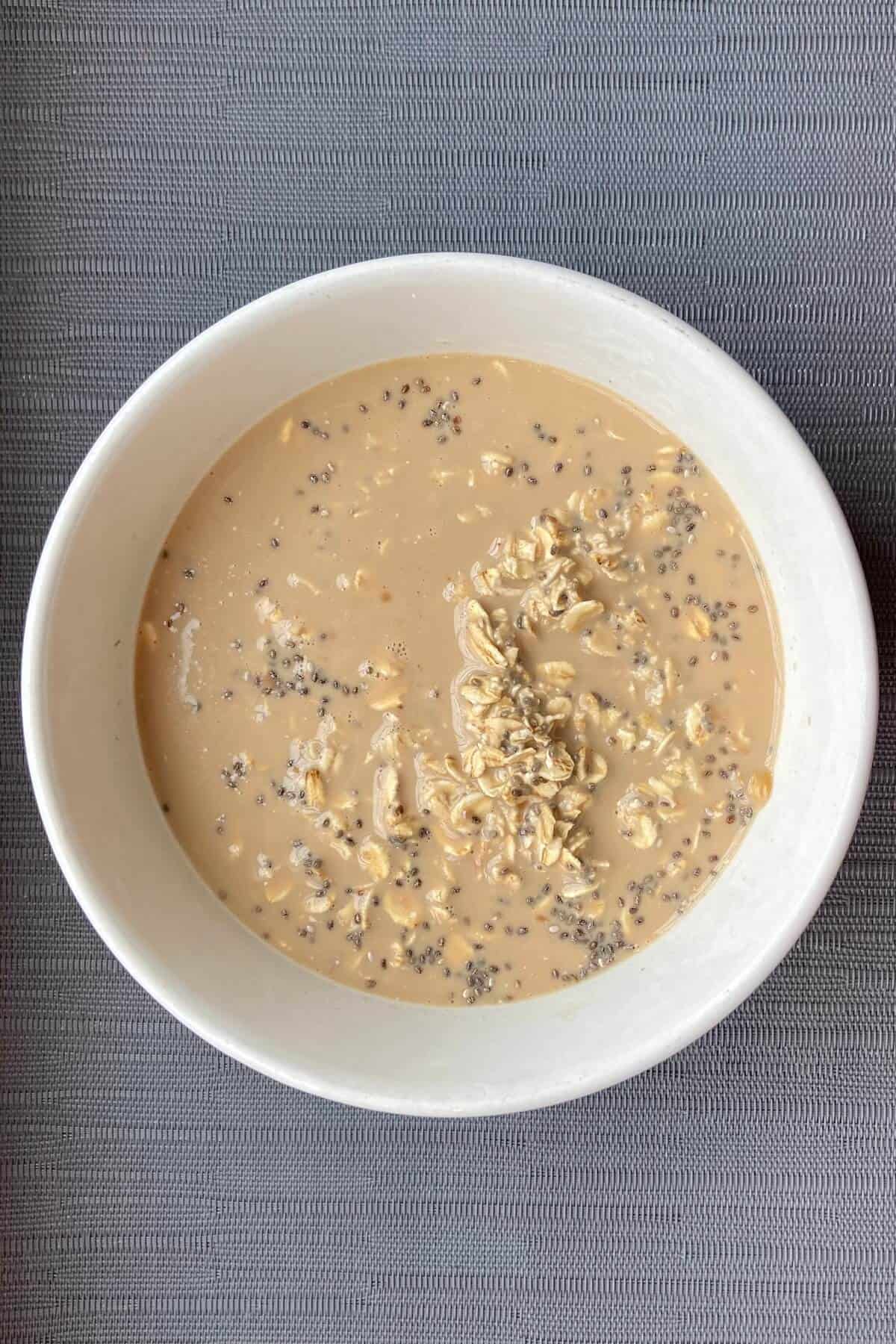 Mixing oats and milk in a bowl.