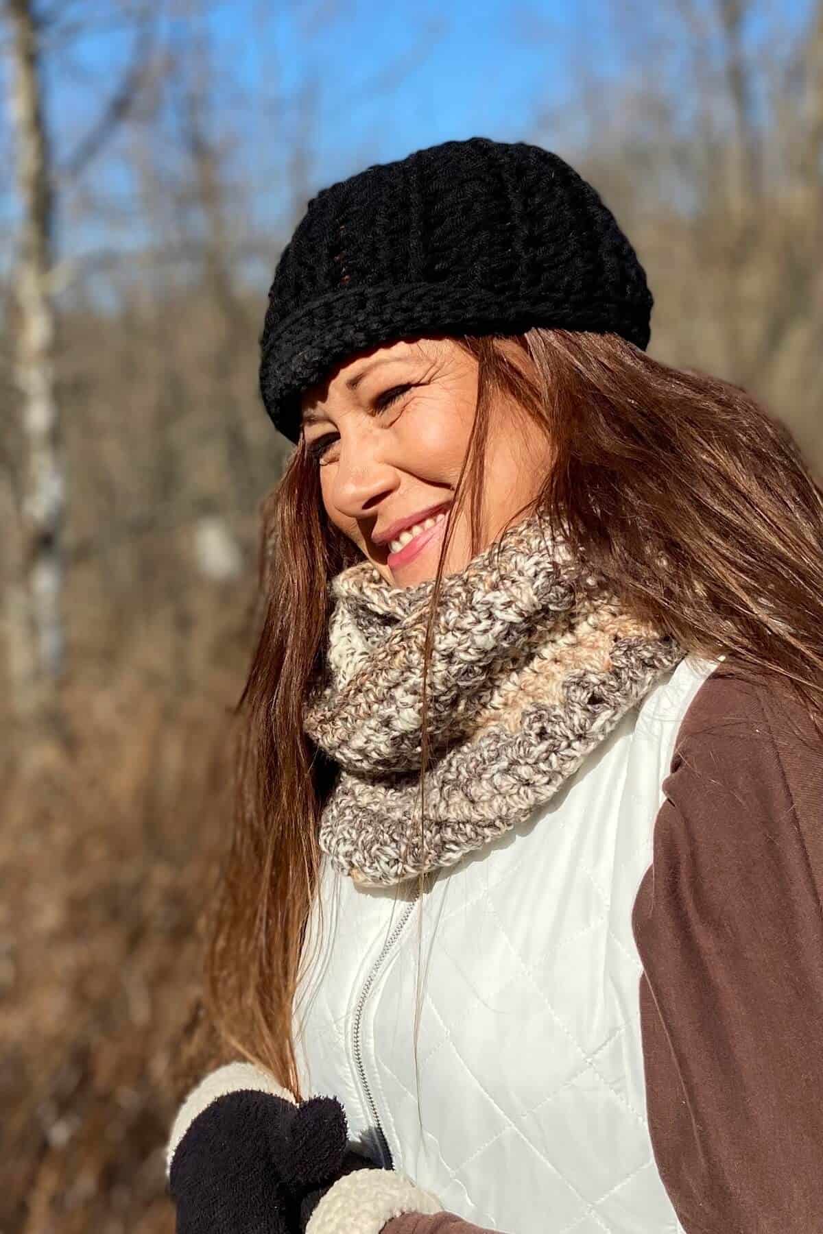 Wearing scarf with vest, gloves, and hat.