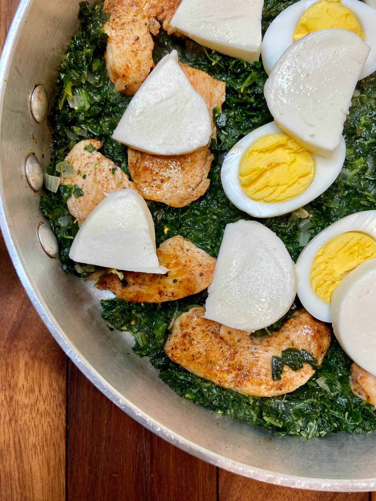 Layered spinach, chicken, eggs, and mozzarella.