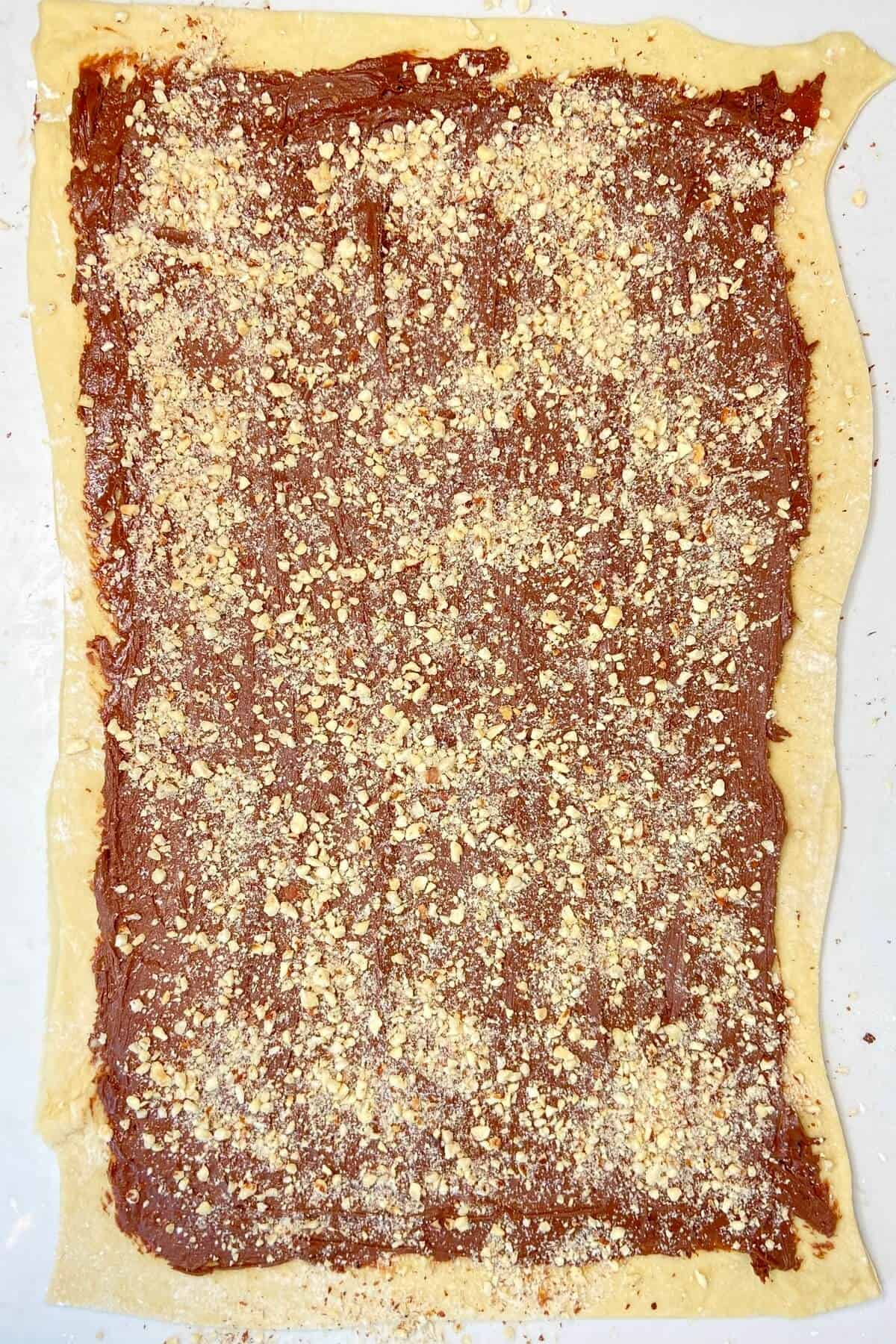 Spread filling and chopped nuts over rolled out dough.