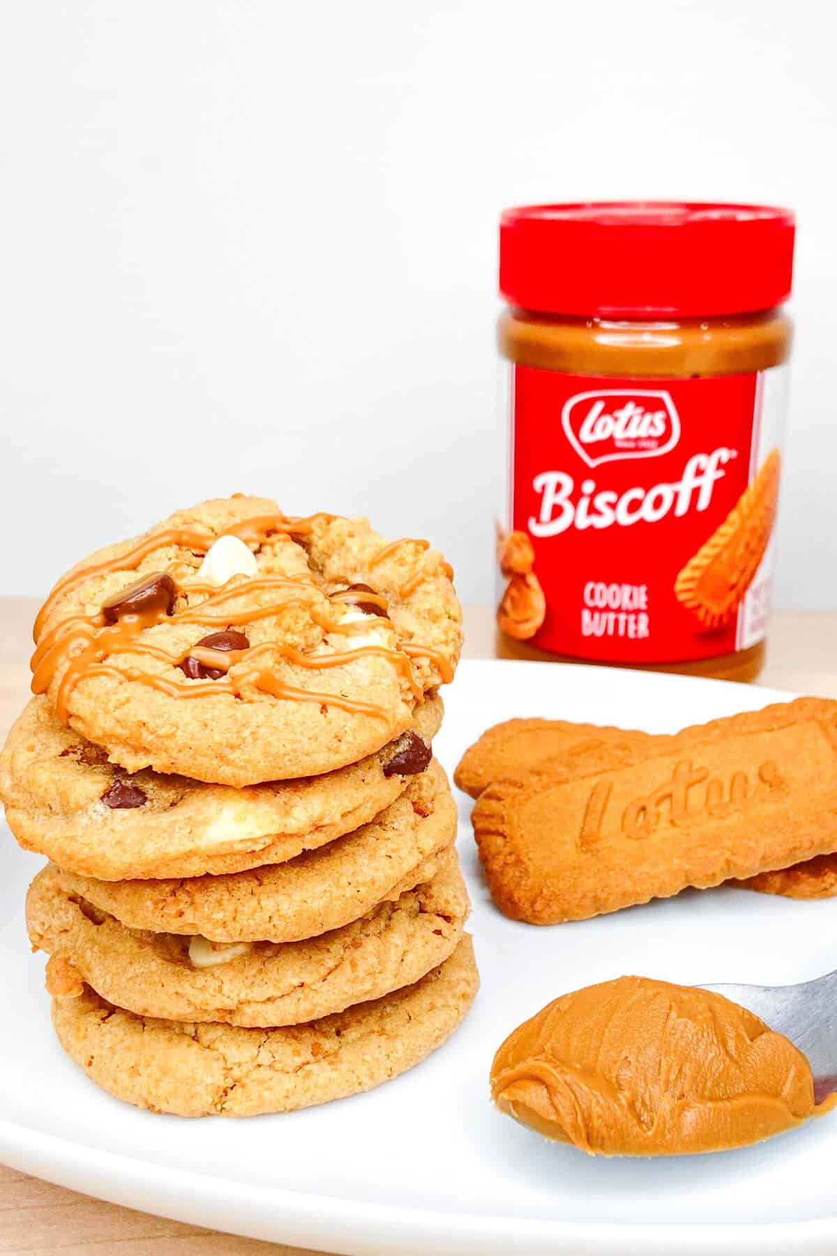 Cookie stack with container of biscoff cookie butter spread.
