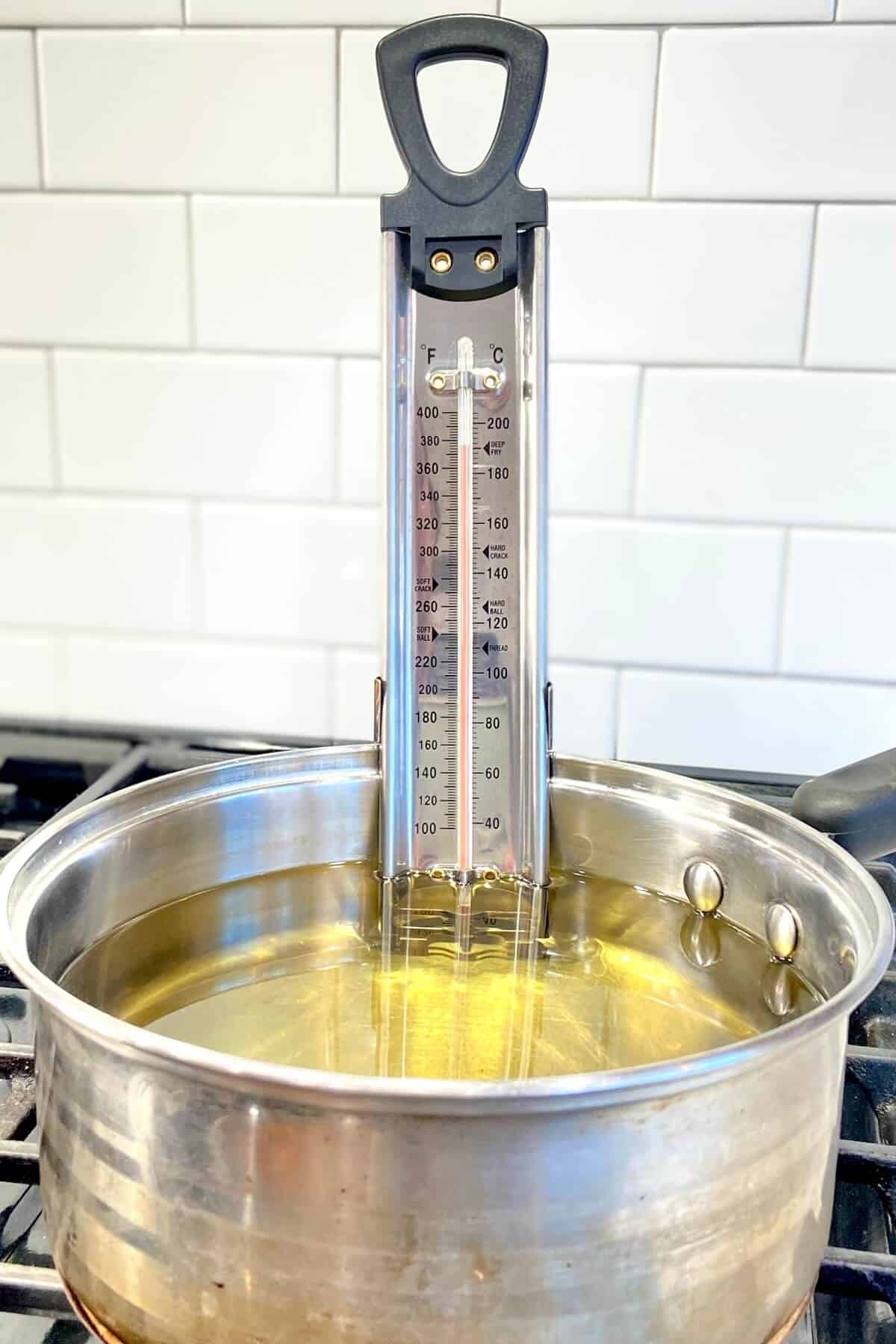 Candy thermometer in pot of oil.