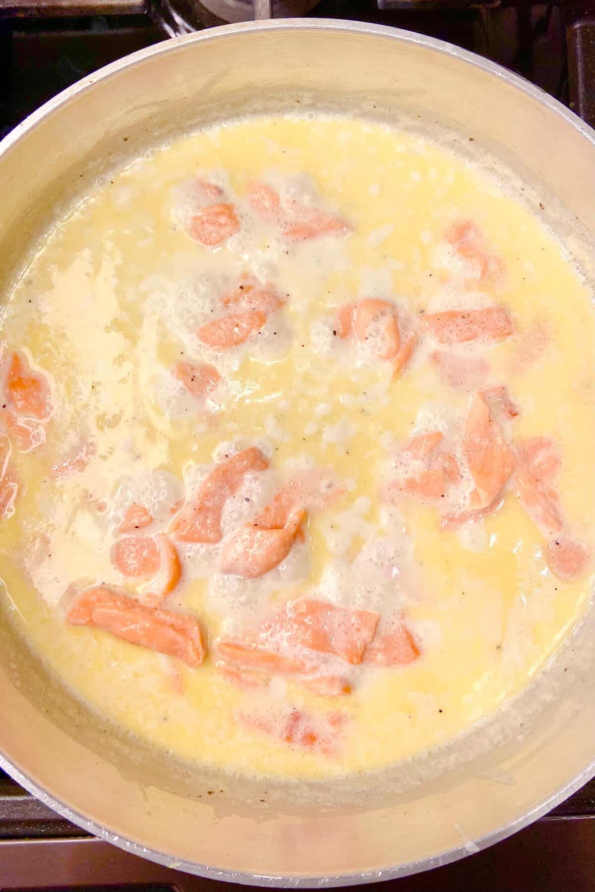 Simmer (not boil) the salmon in the cream and butter.