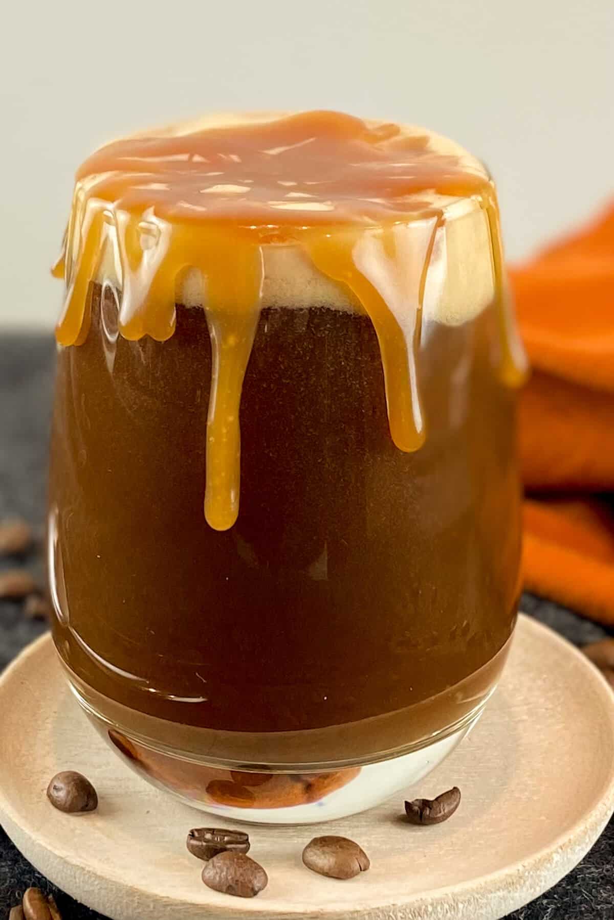 Caramel sauce dripping down sides of cup.