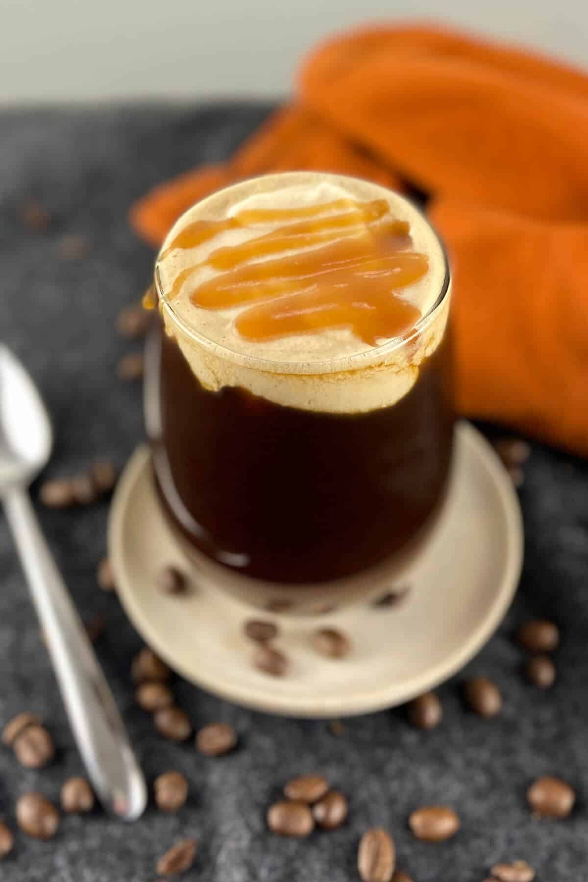 Coffee topped with cold foam and caramel.