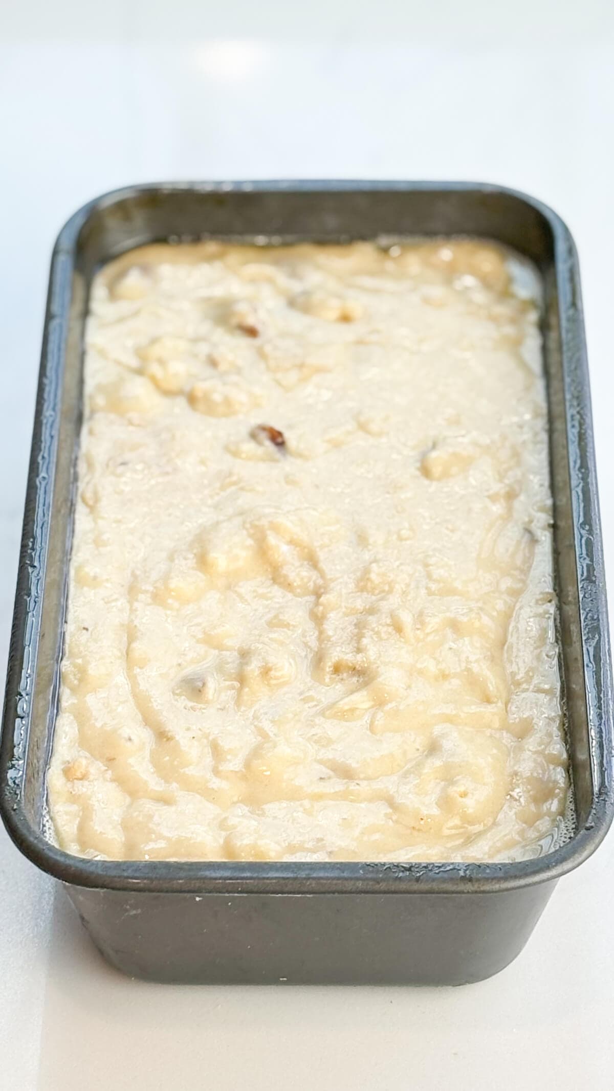 Batter poured into prepared loaf pan for baking.