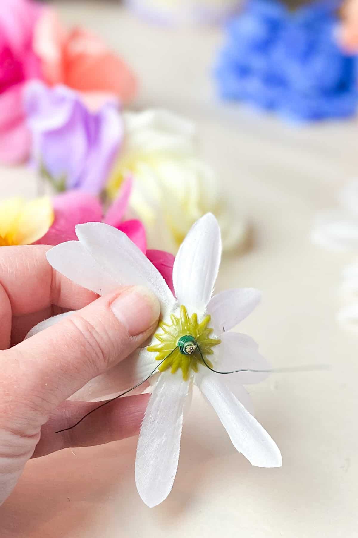 Flower cut near base, then wrapped with wire, and a dab of glue added.