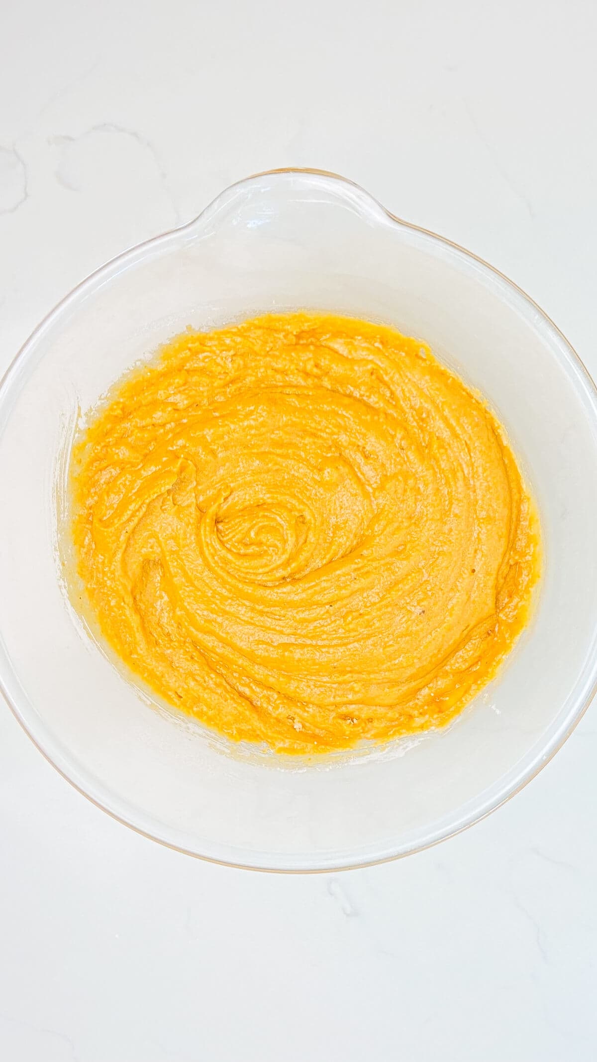 Mixed cookie batter in a large glass bowl.