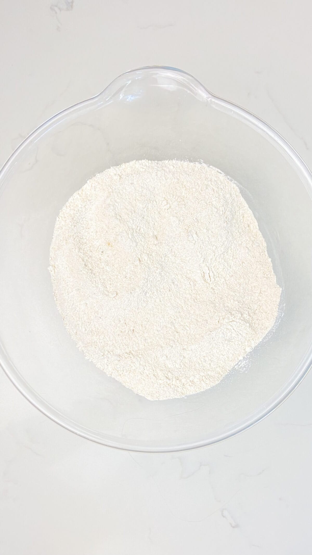 Mixed dry ingredients in a round glass bowl.