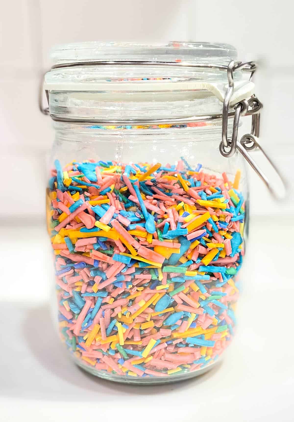 A large glass jar, filled with sprinkles.