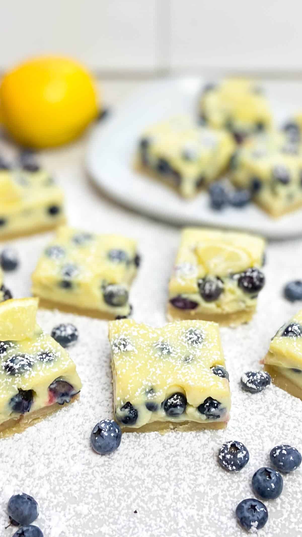 Bars cut into squares and sprinkled with confectioners sugar on top.