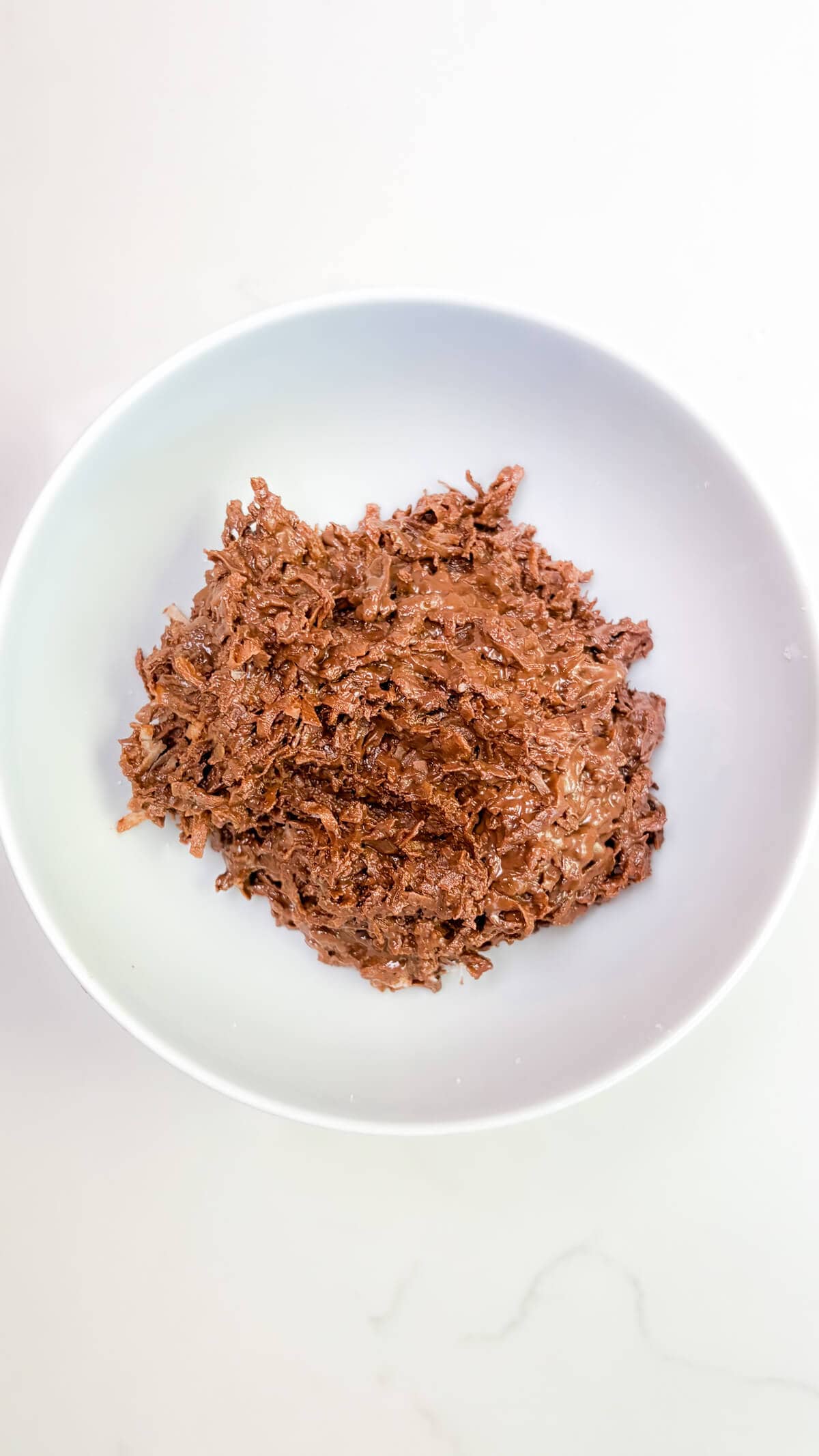 Chocolate and coconut mixed together in a bowl.