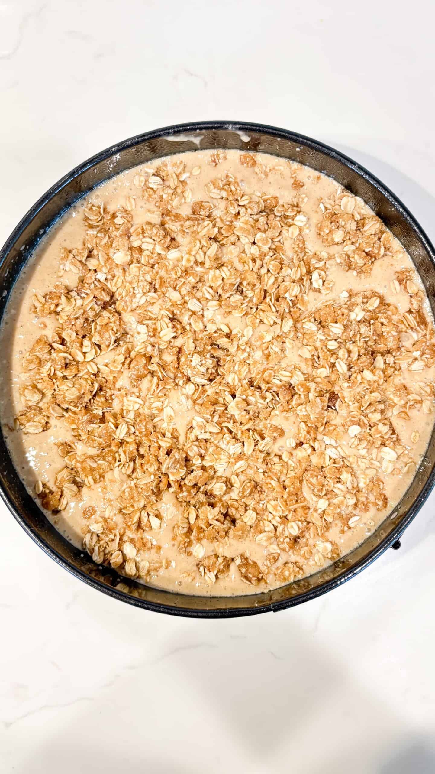 Cake batter poured into pan and topping sprinkled on top.