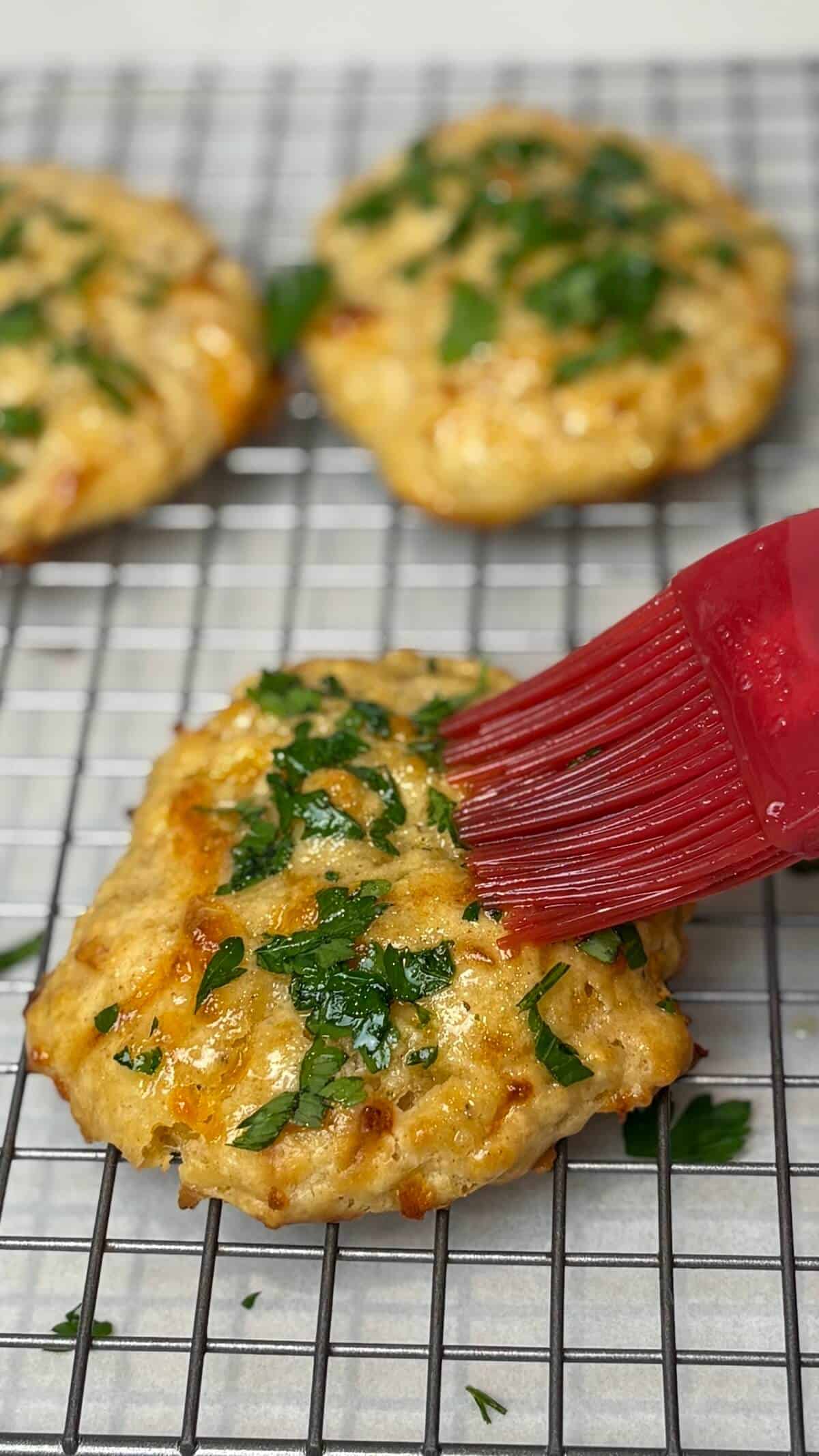 Brushing butter on top.