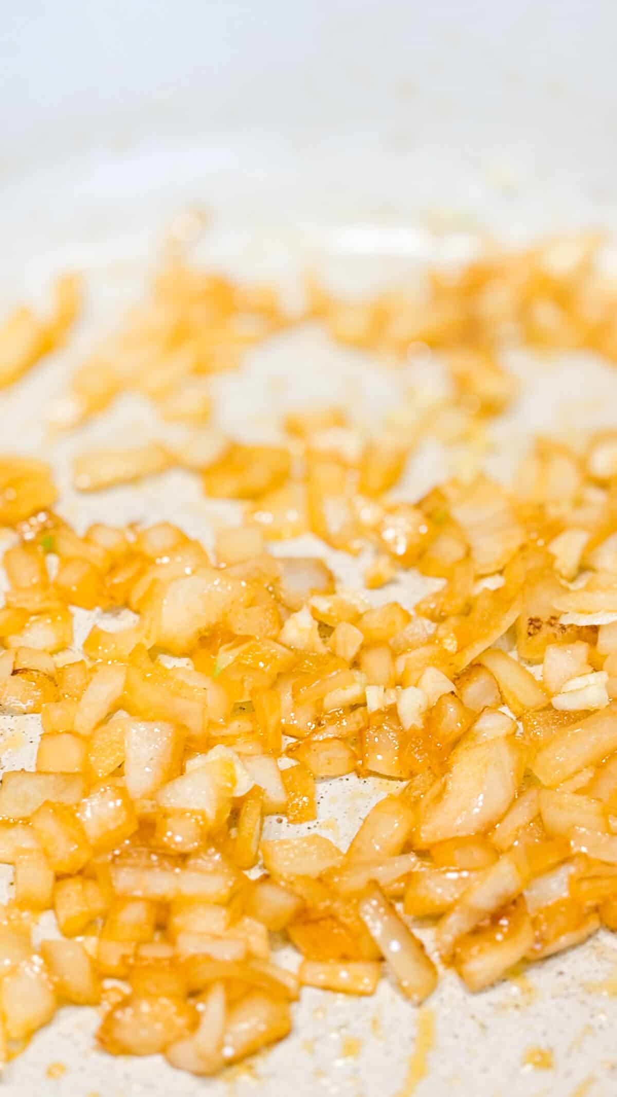 Sauteing onions and garlic in a pan.