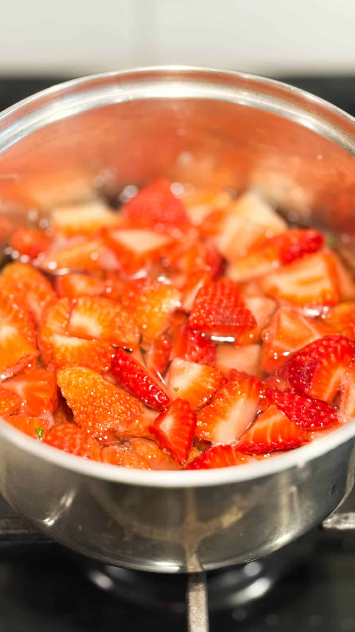 Simple syrup simmering in a pot on the stove.