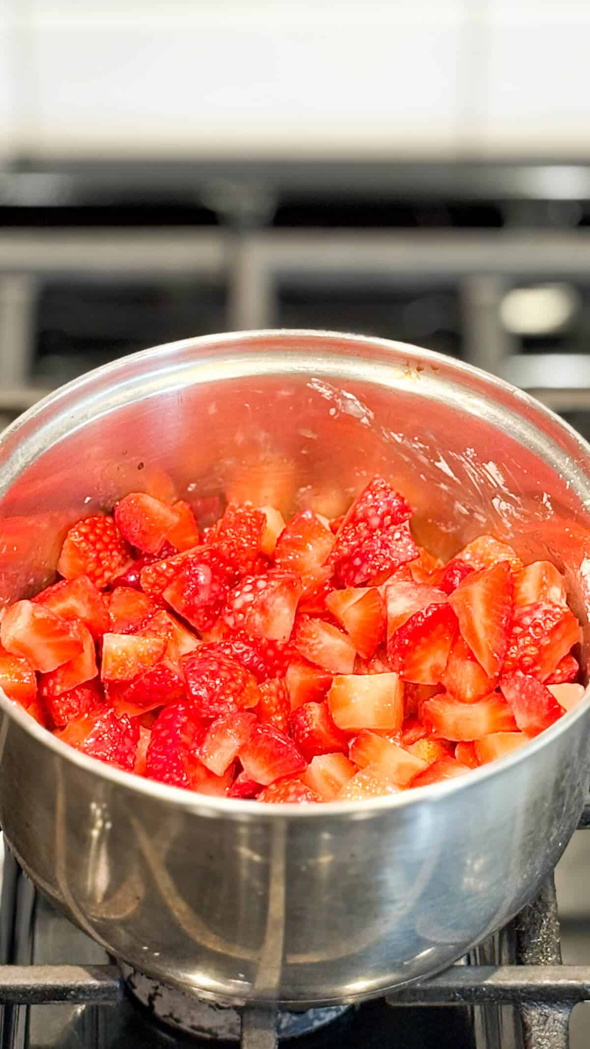 Filling ingredients in a pot on the stove.