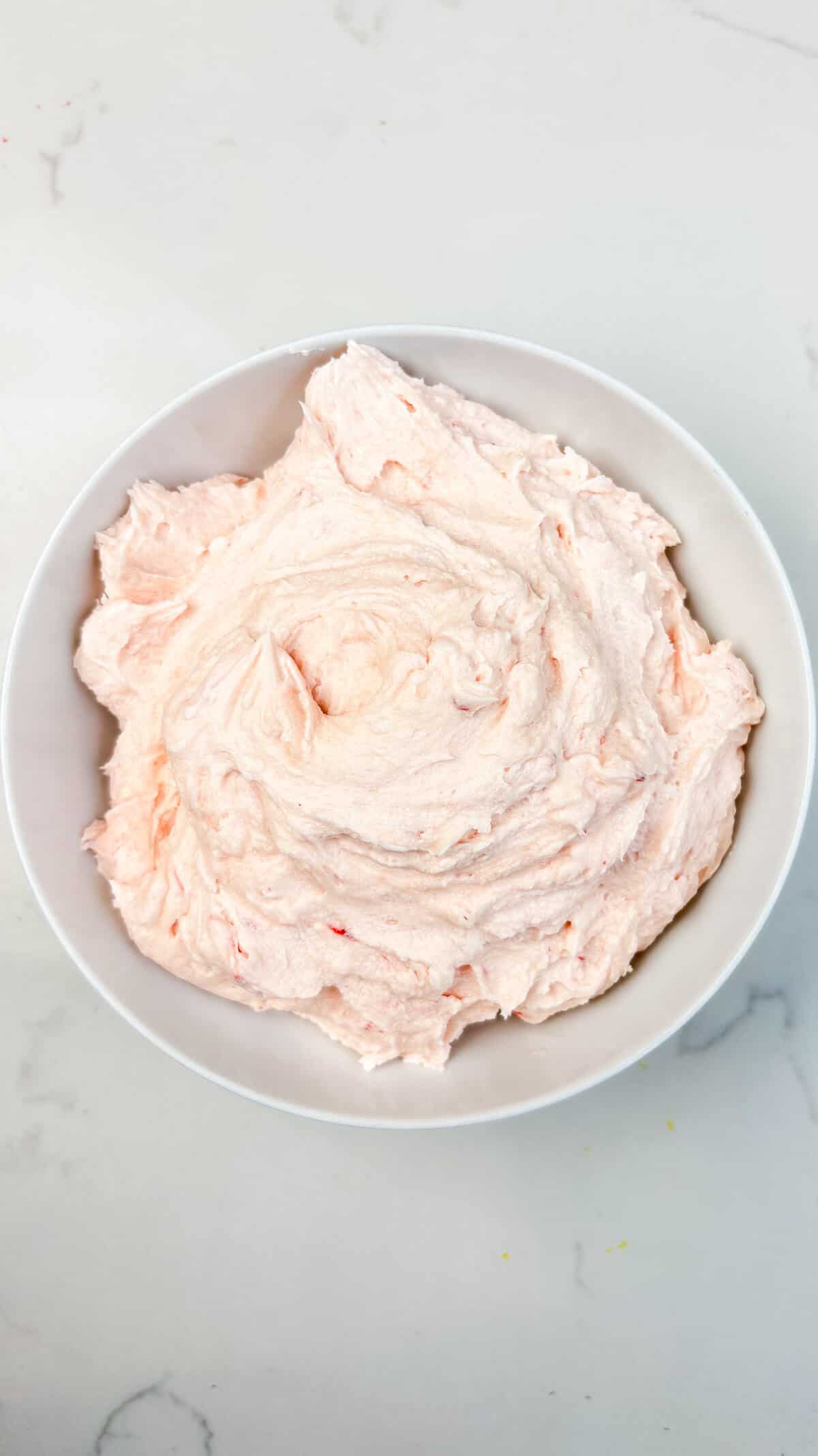 Buttercream frosting mixed in a bowl.